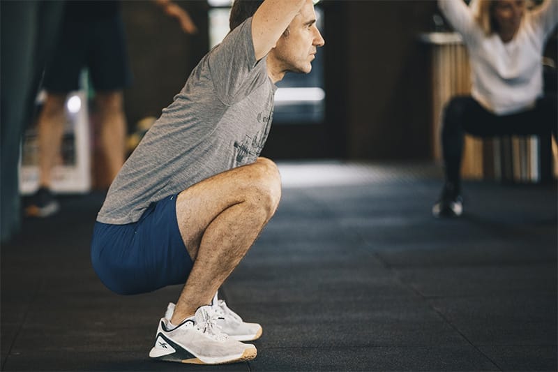 man doing squats at Lake Side Fit